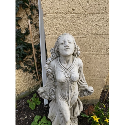 287 - A GARDEN ORNAMENT IN THE FORM OF A FEMALE FIGURE, with a rose blossom scrolling detail around her an... 