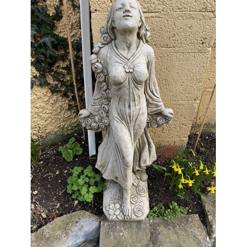 287 - A GARDEN ORNAMENT IN THE FORM OF A FEMALE FIGURE, with a rose blossom scrolling detail around her an... 