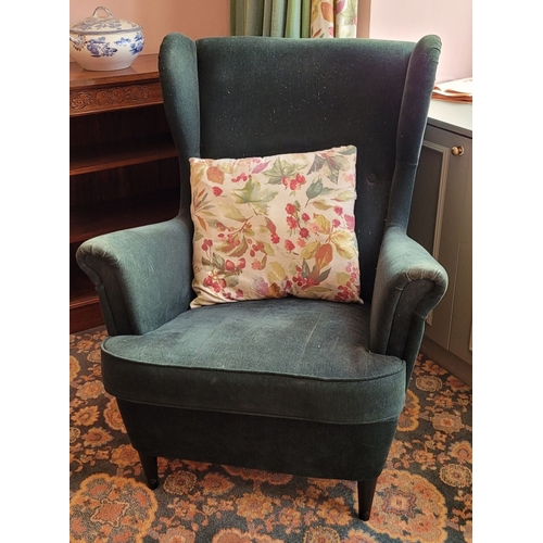 103 - A VERY GOOD CONTEMPORARY WING BACKED ARMCHAIR, in a green upholstery with button detail to the back,... 