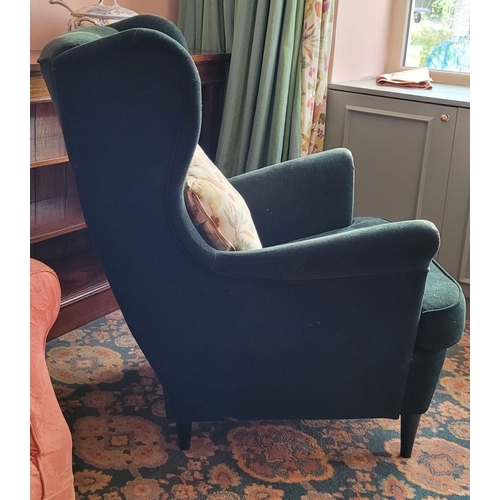 103 - A VERY GOOD CONTEMPORARY WING BACKED ARMCHAIR, in a green upholstery with button detail to the back,... 