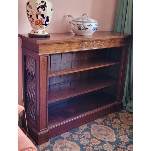 104 - AN EARLY 20TH CENTURY CARVED BREAKFRONT SHAPED OPEN FLOOR BOOKCASE, with open work lattice detail to... 