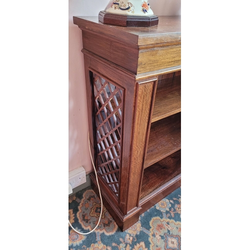 104 - AN EARLY 20TH CENTURY CARVED BREAKFRONT SHAPED OPEN FLOOR BOOKCASE, with open work lattice detail to... 