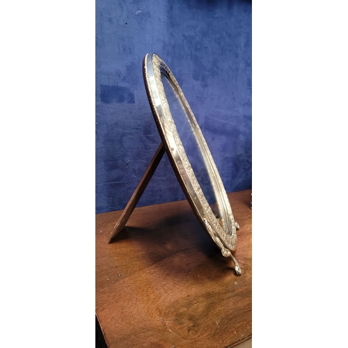 11 - A LOVELY EARLY 20TH CENTURY STERLING SILVER FRAMED TABLE TOP MIRROR, the oval shaped mirror with bev... 