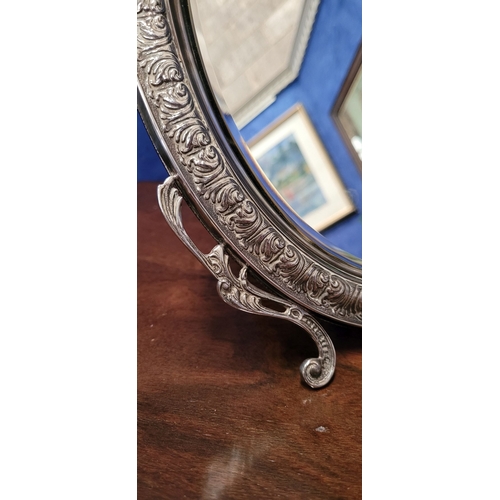 11 - A LOVELY EARLY 20TH CENTURY STERLING SILVER FRAMED TABLE TOP MIRROR, the oval shaped mirror with bev... 