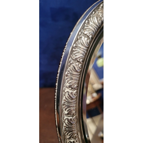 11 - A LOVELY EARLY 20TH CENTURY STERLING SILVER FRAMED TABLE TOP MIRROR, the oval shaped mirror with bev... 