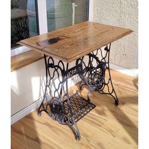 118 - A PINE TOPPED SINGER SEWING MACHINE BASED TABLE, the cast metal base with ‘SINGER’ lettering to the ... 