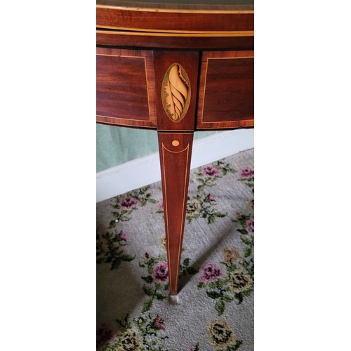 119 - A VERY FINE MAHOGANY INLAID FOLD OVER CARD TABLE, finely inlaid detail to the curved front with shel... 