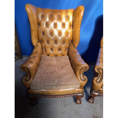 125 - AN EXCELLENT QUALITY PAIR OF TAN LEATHER CHESTERFIELD WINGBACK ARMCHAIRS, each with nice deep button... 