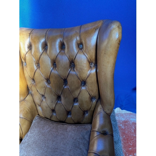 125 - AN EXCELLENT QUALITY PAIR OF TAN LEATHER CHESTERFIELD WINGBACK ARMCHAIRS, each with nice deep button... 