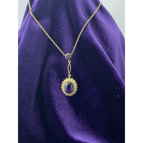 132 - A BEAUTIFUL 9CT GOLD AMETHYST AND SEED PEARL PENDANT NECKLACE, with central large oval cut vibrant a... 