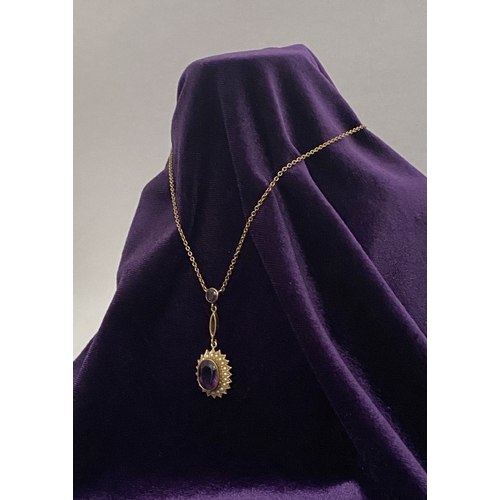 132 - A BEAUTIFUL 9CT GOLD AMETHYST AND SEED PEARL PENDANT NECKLACE, with central large oval cut vibrant a... 