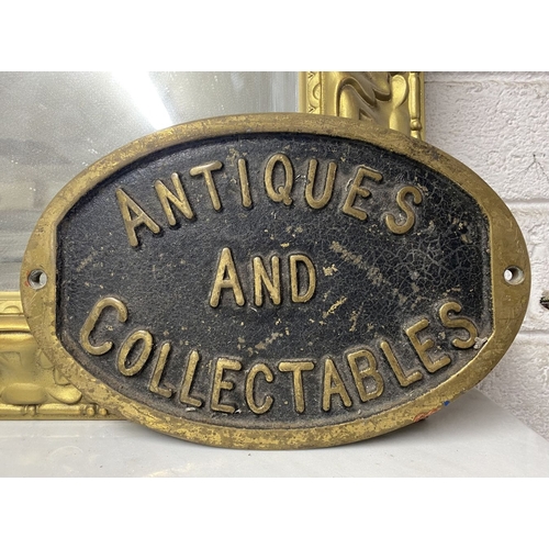 135 - A HEAVY VINTAGE BRASS SIGN, oval form, reading ‘Antiques and Collectables’. Dimensions: 29cm wide x ... 