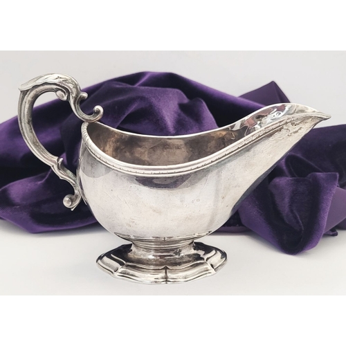 16 - AN EARLY GEORGE III IRISH SILVER SAUCE BOAT, by Richard Williams, c.1760.  Nice simple form with ree... 