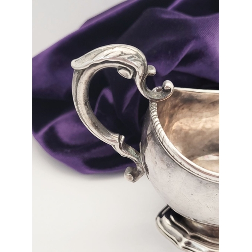 16 - AN EARLY GEORGE III IRISH SILVER SAUCE BOAT, by Richard Williams, c.1760.  Nice simple form with ree... 