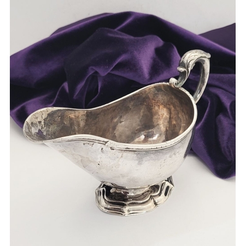 16 - AN EARLY GEORGE III IRISH SILVER SAUCE BOAT, by Richard Williams, c.1760.  Nice simple form with ree... 