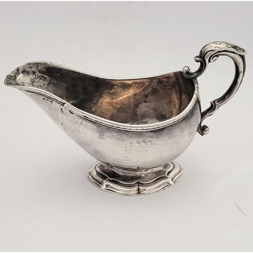 16 - AN EARLY GEORGE III IRISH SILVER SAUCE BOAT, by Richard Williams, c.1760.  Nice simple form with ree... 