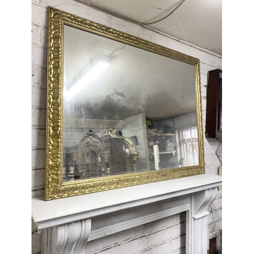 161 - A FINE CARVED GILTWOOD OVERMANTLE MIRROR, rectangular form, the frame is highly detailed. Dimensions... 