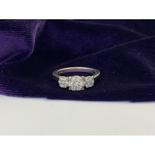 17 - A STUNNING 9CT WHITE GOLD DIAMOND CLUSTER RING, with central round cut diamond surrounded by six fur... 