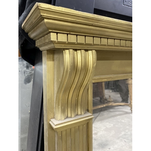 180 - A GILTWOOD OVERMANTLE MIRROR, the frame with dentil cornice, above fluted supports, on stepped base.... 