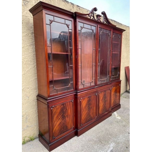 201 - AN EXCELLENT QUALITY MAHOGANY BREAKFRONT LIBRARY BOOKCASE, with openwork carved swan neck pediment t... 