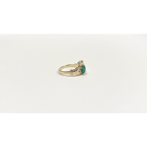 215 - A 10CT YELLOW GOLD GEMSET CLADDAGH RING, the green gemstone set to the centre in a heart shape. Ring... 