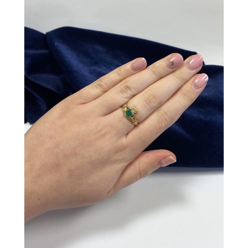 215 - A 10CT YELLOW GOLD GEMSET CLADDAGH RING, the green gemstone set to the centre in a heart shape. Ring... 