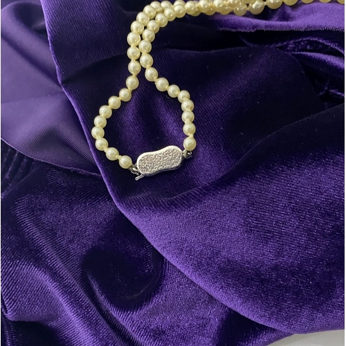 217 - TWO LOVELY IMITATION PEARL NECKLACES, (i) double strand with imitation pearls graduating in size fro... 