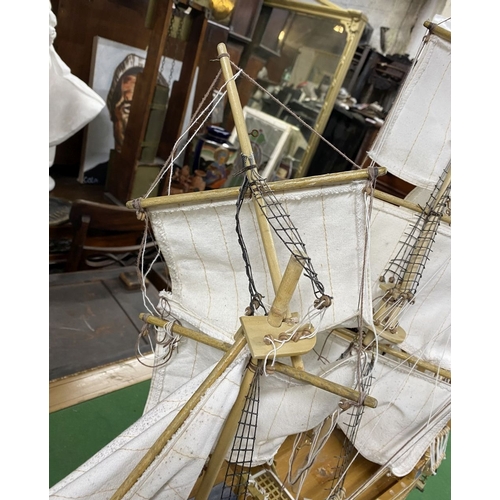 222 - A VINTAGE MODEL OF A SHIP, on base, some restoration needed, masts in need of resetting etc. Dimensi... 