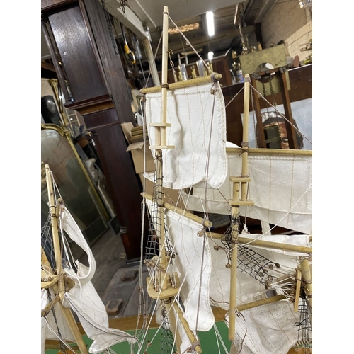 222 - A VINTAGE MODEL OF A SHIP, on base, some restoration needed, masts in need of resetting etc. Dimensi... 