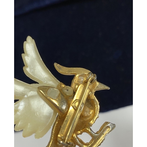 257 - A VINTAGE GOLD TONE CARVED CELLULOID WINGS BIRD BROOCH, finely decorated, with multi tone gemstones ... 