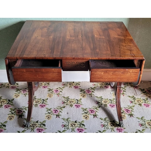 26 - A VERY GOOD QUALITY REGENCY ROSEWOOD BRASS INLAID SOFA TABLE, the curved leaves on each side raised ... 