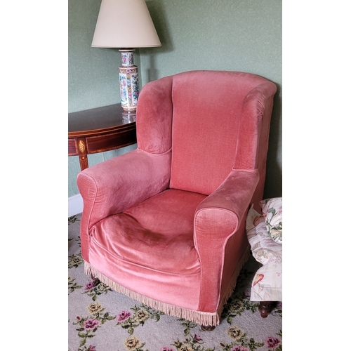 264 - TWO ANTIQUE ARMCHAIRS: (i) A WING BACKED ARMCHAIR, raised on turned leg with frill detail to the uph... 