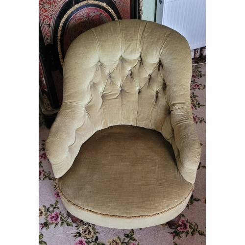 265 - A LOW-RISE EARLY 20TH CENTURY BUTTON BACKED ARMCHAIR, with curved back rest that runs into the armre... 