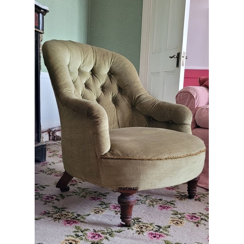 265 - A LOW-RISE EARLY 20TH CENTURY BUTTON BACKED ARMCHAIR, with curved back rest that runs into the armre... 