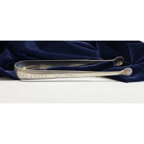 277 - A GEORGE III BRIGHT CUT SILVER SUGAR TONGS, by Benjamin Taitt, Dublin c.1790. The handles with intri... 