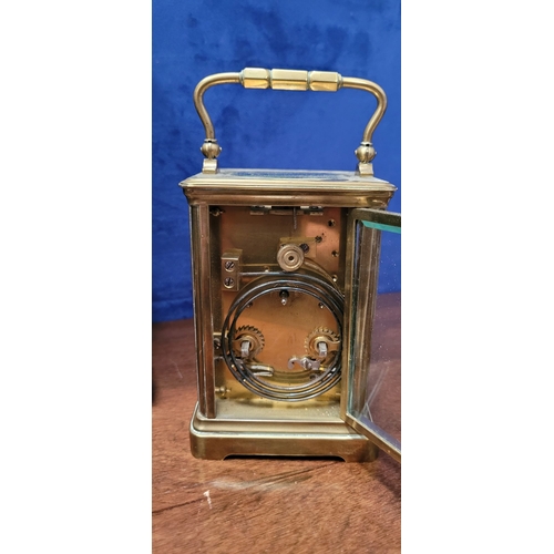 288 - A GOOD QUALITY BRASS CARRIAGE CLOCK, with bevelled glass panes on all sides including the top. The d... 