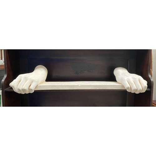 318 - A PLASTER CAST HANGING SHELF, in the form of pair of hands holding shelf, handing hooks to reverse. ... 