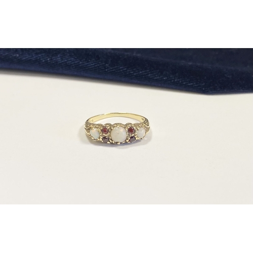 319 - A LOVELY 9CT YELLOW GOLD OPAL & GARNET RING, set with three round cut vibrant opals, four round cut ... 