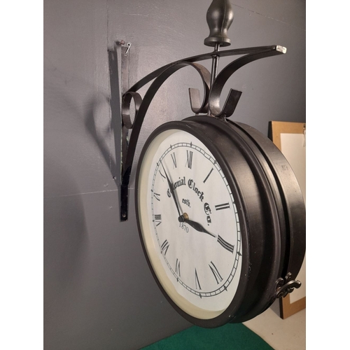 327 - A DOUBLE SIDED METAL WALL HANGING CLOCK, by Colonial Clock Co, Estb. 1870, in working order. Bracket... 