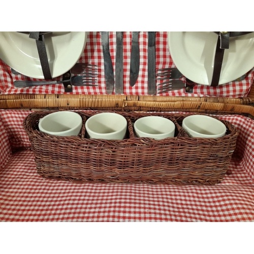 332 - AN ELEGANT VINTAGE WICKER PICNIC BASKET, with gingham lined interior, carrying handles and straps. I... 