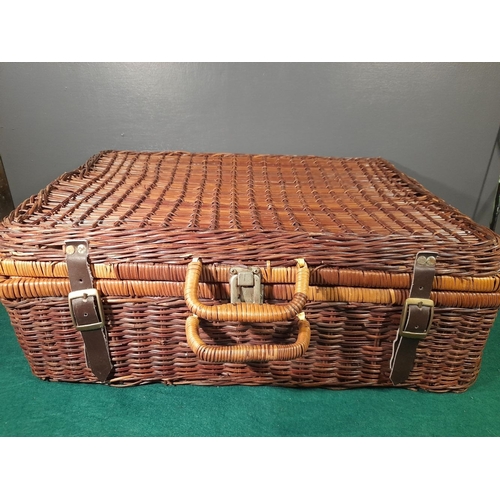 332 - AN ELEGANT VINTAGE WICKER PICNIC BASKET, with gingham lined interior, carrying handles and straps. I... 