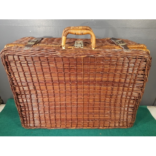 332 - AN ELEGANT VINTAGE WICKER PICNIC BASKET, with gingham lined interior, carrying handles and straps. I... 