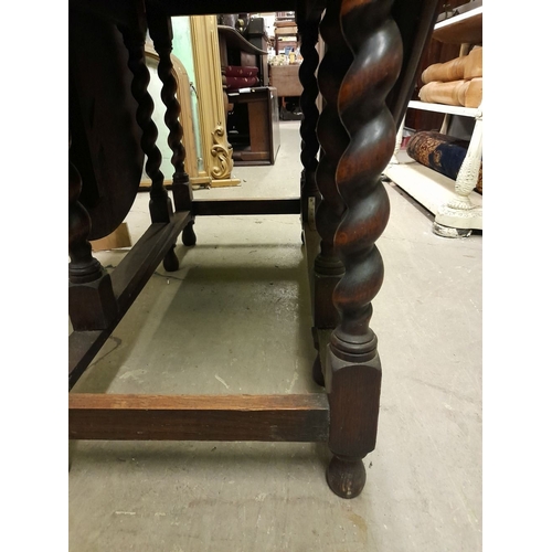 334 - AN OAK BARLEY TWIST GATE LEG SUTHERLAND TABLE, in overall good condition, with repair needed to one ... 