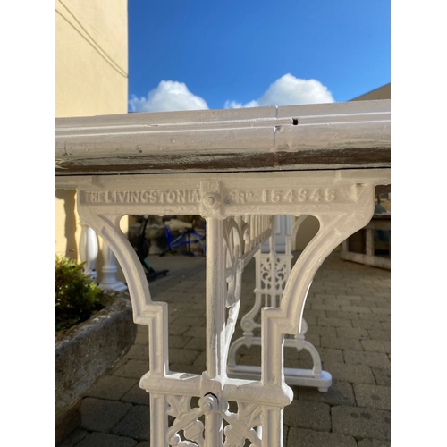 355 - A VINTAGE CAST IRON GARDEN/PATIO TABLE, the stepped rectangular top on decorative openwork side supp... 