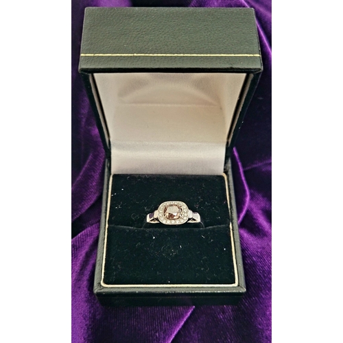 36 - A PRETTY DIAMOND CLUSTER RING – with a oval shaped natural fancy pink/brown diamond to the centre; a... 