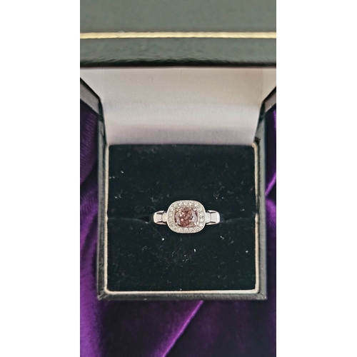 36 - A PRETTY DIAMOND CLUSTER RING – with a oval shaped natural fancy pink/brown diamond to the centre; a... 