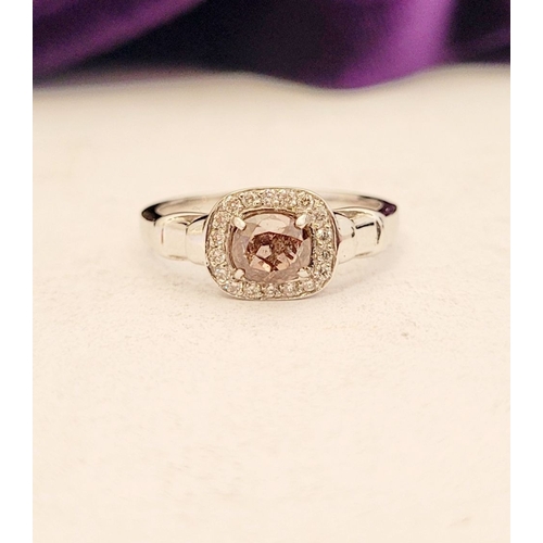 36 - A PRETTY DIAMOND CLUSTER RING – with a oval shaped natural fancy pink/brown diamond to the centre; a... 