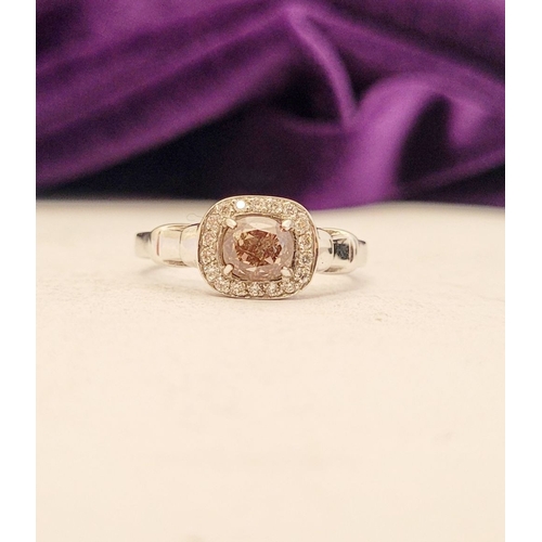 36 - A PRETTY DIAMOND CLUSTER RING – with a oval shaped natural fancy pink/brown diamond to the centre; a... 