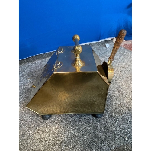 365 - A BRASS SLOPE FRONT COAL SCUTTLE, the front with embossed floral panel, handle to top, shovel with h... 