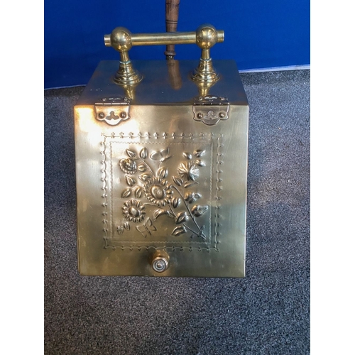 365 - A BRASS SLOPE FRONT COAL SCUTTLE, the front with embossed floral panel, handle to top, shovel with h... 